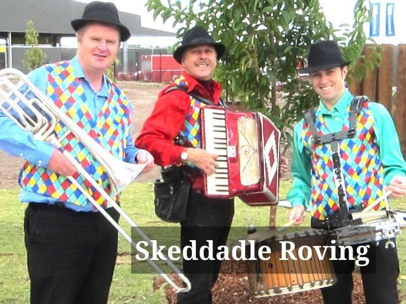 Roving musicians in brightly coloured shirts - trombone, accordion and drums