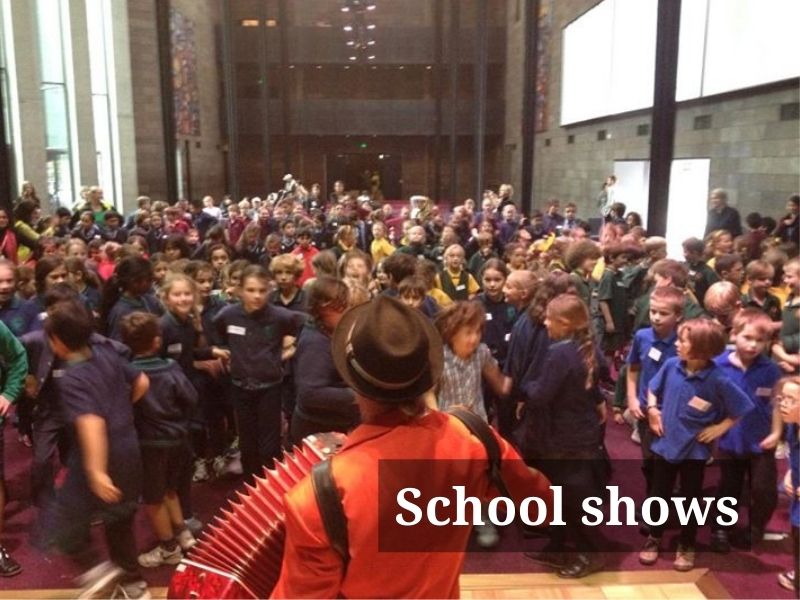 Accordionist playing to roomful of schoolchildren